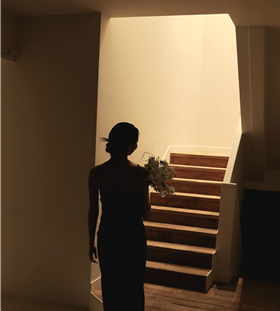 Silhouette of the Greenish Aloe blogger holding a bouquet, face not shown