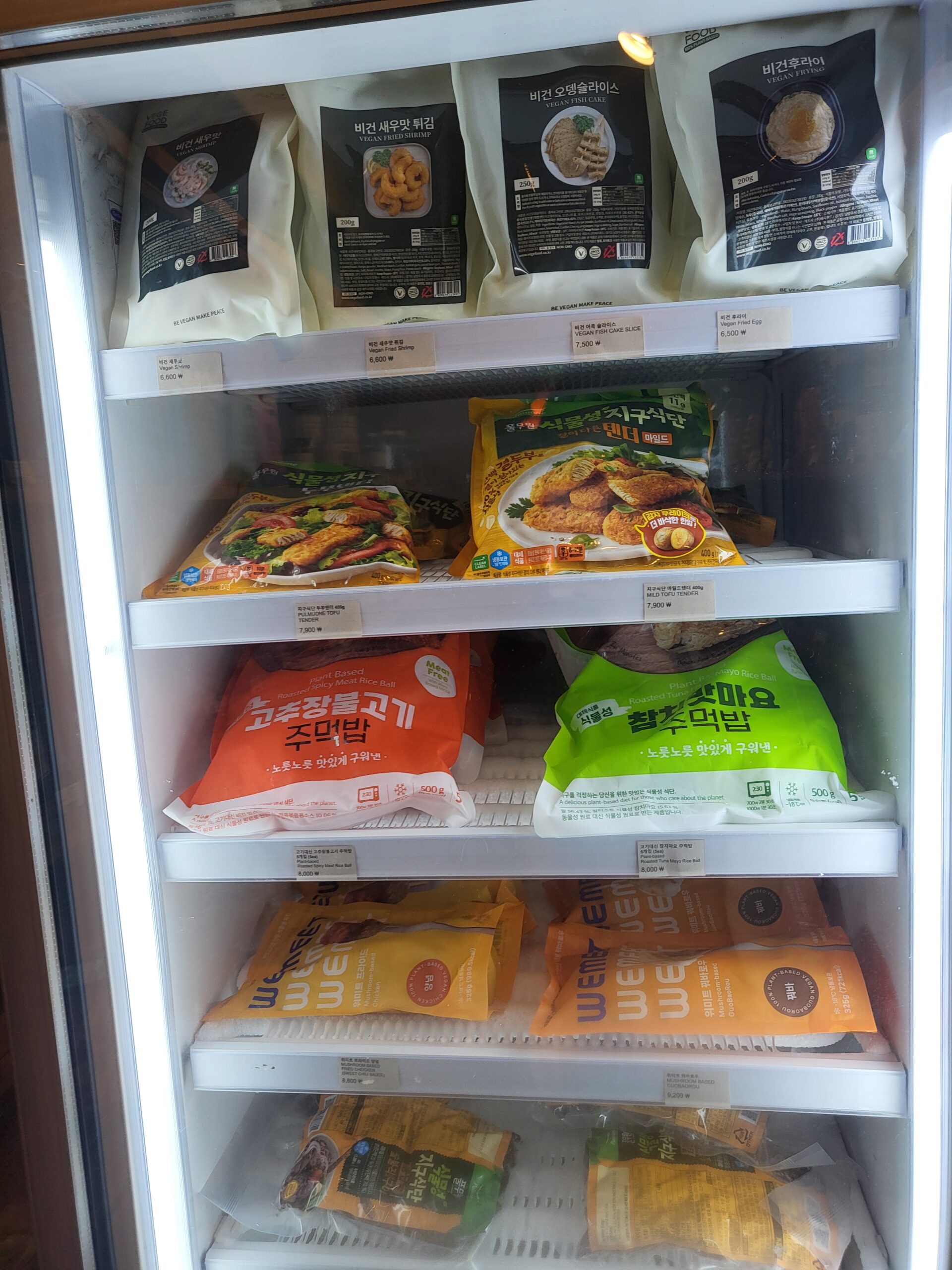 The frozen case, all vegan — mock fried shrimp, fish cake slices, and a brand simply called WeMeat